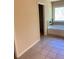 A neutral bathroom featuring tile flooring, a tub, and an adjacent walk-in closet at 526 Blue Mountain Rise, Canton, GA 30114