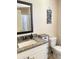 Neutral bathroom featuring granite counters and a framed mirror at 526 Blue Mountain Rise, Canton, GA 30114