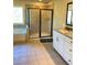 Bathroom with a soaking tub and glass-enclosed shower, granite counters and tile flooring at 526 Blue Mountain Rise, Canton, GA 30114