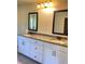 Bathroom featuring a double vanity with granite countertops, tiled flooring, and framed mirrors at 526 Blue Mountain Rise, Canton, GA 30114