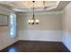 Elegant dining room featuring coffered ceiling, hardwood floors, wainscoting, and a chandelier at 526 Blue Mountain Rise, Canton, GA 30114