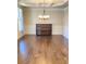 Elegant dining room featuring a coffered ceiling, wainscoting, chandelier, hardwood floors, and a piano at 526 Blue Mountain Rise, Canton, GA 30114