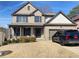 Charming brick two-story home featuring a welcoming front porch, dark shutters, and a well-maintained lawn at 526 Blue Mountain Rise, Canton, GA 30114