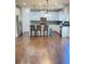 Modern kitchen with white cabinets, stainless steel appliances, granite countertops, and hardwood flooring at 526 Blue Mountain Rise, Canton, GA 30114