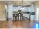 Bright kitchen featuring white cabinets, stainless steel appliances, granite countertops, and hardwood floors at 526 Blue Mountain Rise, Canton, GA 30114