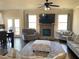 Cozy living room featuring a stone fireplace, ceiling fan, plush seating, and hardwood flooring at 526 Blue Mountain Rise, Canton, GA 30114