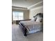 Spacious primary bedroom featuring a tray ceiling, plush carpet, and a cozy bed with decorative pillows at 526 Blue Mountain Rise, Canton, GA 30114