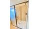 Modern shower with glass door, tiled walls, shower seat, and bronze fixtures at 526 Blue Mountain Rise, Canton, GA 30114