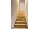 Wooden staircase with white railing leading up to the second floor at 526 Blue Mountain Rise, Canton, GA 30114