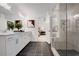 Modern bathroom with glass enclosed shower, dual sink vanity, and black tiled floor at 6095 Marigold Way, Atlanta, GA 30349