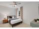 Cozy bedroom featuring shiplap wall, ceiling fan, and plush carpeting at 6095 Marigold Way, Atlanta, GA 30349