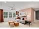 Bright bonus room featuring a neutral sofa, stylish decor, and large windows at 6095 Marigold Way, Atlanta, GA 30349
