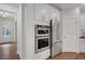 Bright kitchen features stainless steel appliances and white cabinets at 6095 Marigold Way, Atlanta, GA 30349