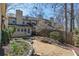 A well-maintained backyard with a stone and gravel walkway, manicured garden beds, and the back of the townhome in the background at 1281 Whitlock Ridge Sw Dr, Marietta, GA 30064