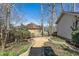 Backyard landscape featuring a gravel path surrounded by trees and greenery at 1281 Whitlock Ridge Sw Dr, Marietta, GA 30064