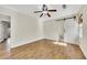 Bedroom featuring hardwood floors, a ceiling fan, and a sliding barn door at 1281 Whitlock Ridge Sw Dr, Marietta, GA 30064