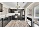 Kitchen featuring black appliances, ample cabinet space and laminate floors at 1281 Whitlock Ridge Sw Dr, Marietta, GA 30064