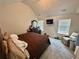 Carpeted bedroom featuring a plush recliner and an ensuite bathroom at 6497 Snowden Dr, South Fulton, GA 30349