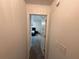 Hallway leading into a bedroom, with neutral-colored walls and carpet at 6497 Snowden Dr, South Fulton, GA 30349