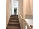 Carpeted staircase with white painted wood railing at 6497 Snowden Dr, South Fulton, GA 30349