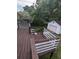 Wooden deck with white railings overlooks a green backyard with a garage at 6977 Eunice Dr, Riverdale, GA 30274