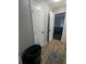 Hallway leading to a bedroom, with a laundry basket, and tiled floor at 6977 Eunice Dr, Riverdale, GA 30274