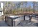 Enclosed deck with hot tub and wooded view offers privacy and space for relaxation at 1675 Dodson Sw Dr, Atlanta, GA 30311