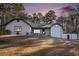 Charming single-story home with a textured facade, complemented by mature trees and a spacious front yard at 1675 Dodson Sw Dr, Atlanta, GA 30311