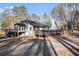 This house features a deck and driveway nestled amongst mature trees at 1675 Dodson Sw Dr, Atlanta, GA 30311