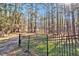 Gated entrance to the property through mature hardwoods at 1675 Dodson Sw Dr, Atlanta, GA 30311