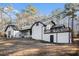 View of the back of the home, showcasing a elevated patio and neutral color palette at 1675 Dodson Sw Dr, Atlanta, GA 30311