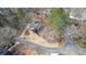 Aerial view of the property surrounded by mature trees, landscaping, and a circular driveway on a quiet street at 493 Willow Springs Dr, Marietta, GA 30068