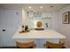 Basement bar area featuring a mini fridge, decor, quartz countertops, and white cabinets at 493 Willow Springs Dr, Marietta, GA 30068