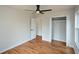 Bedroom with hardwood floors, neutral walls, and a ceiling fan; view of doorway and closet at 493 Willow Springs Dr, Marietta, GA 30068