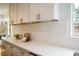 Close-up of the modern kitchen with white stone countertops, white cabinets, and stainless steel appliances at 493 Willow Springs Dr, Marietta, GA 30068