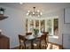 Bright dining room with a modern chandelier, natural light, and peaceful views at 493 Willow Springs Dr, Marietta, GA 30068