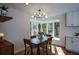 Charming dining area with a modern chandelier, natural light, and serene views at 493 Willow Springs Dr, Marietta, GA 30068