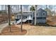 Unique contemporary home features a blue gray exterior, white trim and steps, and mature trees at 493 Willow Springs Dr, Marietta, GA 30068