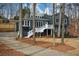 Contemporary home with a blue gray exterior, white trim, fresh landscaping and a long driveway at 493 Willow Springs Dr, Marietta, GA 30068