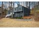 View of the contemporary gray home with a well-maintained lawn and lush landscaping at 493 Willow Springs Dr, Marietta, GA 30068