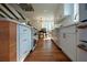 Modern kitchen with stone countertops, stainless steel appliances, and hardwood flooring, connected to dining area at 493 Willow Springs Dr, Marietta, GA 30068