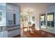 Bright breakfast nook with modern lighting, view of outdoor screened porch and stainless steel refrigerator at 493 Willow Springs Dr, Marietta, GA 30068