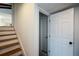 View of the wooden staircase with white risers and an open doorway, providing a bright and welcoming transition at 493 Willow Springs Dr, Marietta, GA 30068