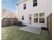 Backyard with grass, a small concrete patio, wooden fence and view of the rear of the home at 1622 Aiden Way # 62, Conyers, GA 30013