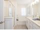 Bright bathroom featuring a soaking tub, glass-enclosed shower, and double vanity with modern fixtures at 1622 Aiden Way # 62, Conyers, GA 30013