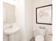 Bright half bath features a pedestal sink and artwork at 1622 Aiden Way # 62, Conyers, GA 30013