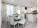Cozy dining space complemented by designer curtains, stainless appliances and generous natural light at 1622 Aiden Way # 62, Conyers, GA 30013