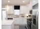Modern white kitchen featuring stainless steel appliances and pendant lighting at 1622 Aiden Way # 62, Conyers, GA 30013