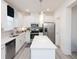 Modern kitchen with stainless steel appliances, an island, and stylish pendant lighting over clean, white countertops at 1622 Aiden Way # 62, Conyers, GA 30013