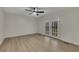 Bright bedroom features light wood floors, ceiling fan, and double doors to the outside at 2328 Carnes Rd, Jonesboro, GA 30236